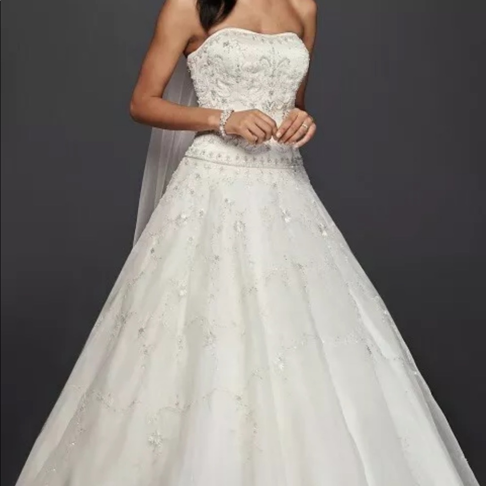 Oleg Cassini wedding dress. Size 12 Ivory. With mantilla veil. Preserved.